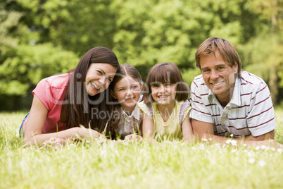 Family outdoors smiling