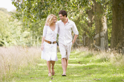 Couple walking on path smiling