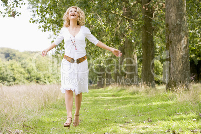 Woman walking on path smiling