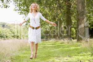 Woman walking on path smiling