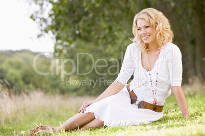 Woman sitting outdoors smiling