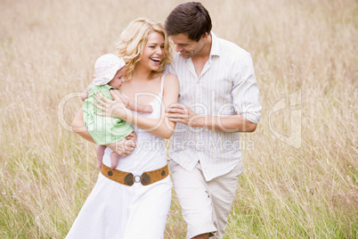 Family walking outdoors smiling