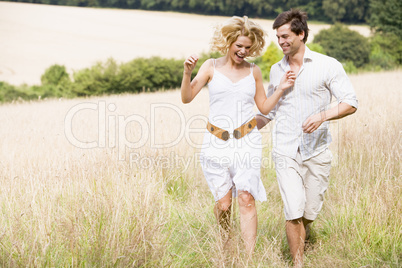 Couple running outdoors smiling