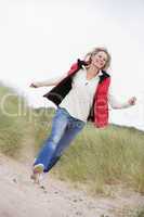 Woman running at beach smiling