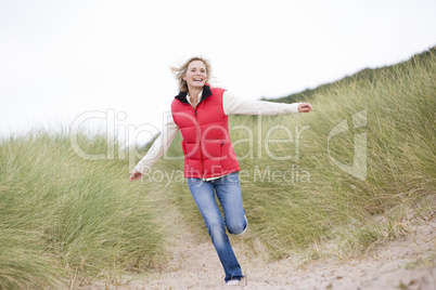 Woman running at beach smiling