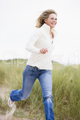 Woman running at beach smiling