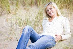 Woman lying on beach smiling