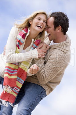 Couple standing outdoors smiling