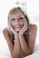 Woman lying in bed smiling