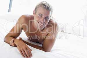 Man lying in bed smiling