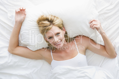 Woman lying in bed smiling