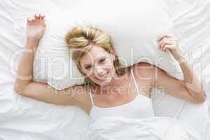 Woman lying in bed smiling