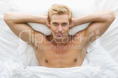 Man lying in bed relaxing