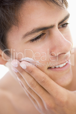 Man putting on shaving cream smiling