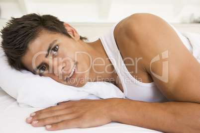 Man lying in bed smiling