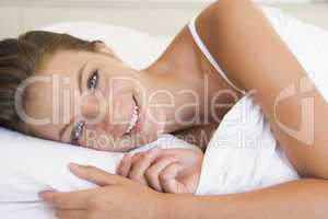 Woman lying in bed smiling