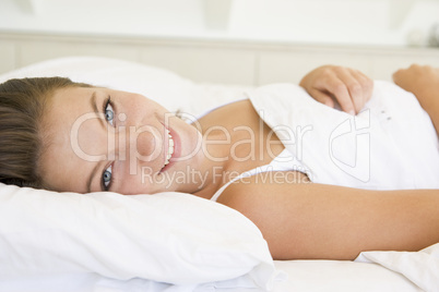 Woman lying in bed smiling