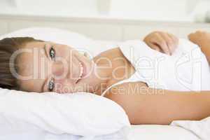 Woman lying in bed smiling