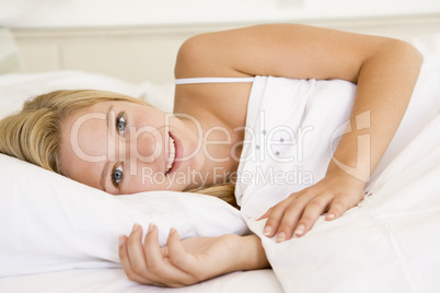 Woman lying in bed smiling