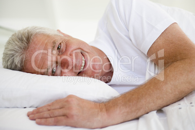 Man lying in bed smiling