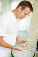 Man in bathroom with hair gel