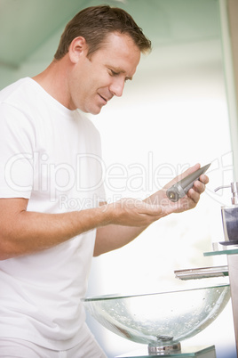 Man in bathroom applying aftershave