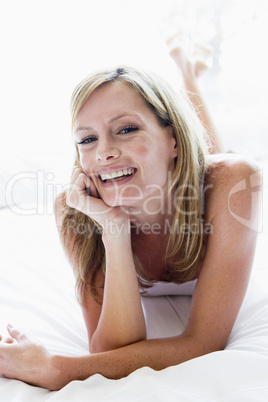 Woman lying in bed laughing