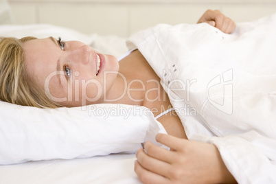 Woman lying in bed smiling