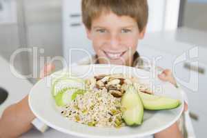 Boy holding plate of food