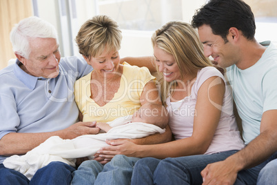 Family in living room with baby smiling