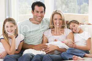 Family in living room with baby smiling