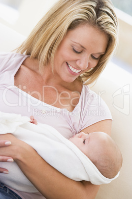 Mother in living room with baby smiling