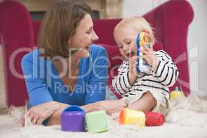 Mother in living room playing with baby smiling