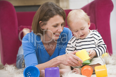 Mother in living room playing with baby smiling