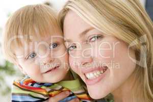 Mother and young boy indoors smiling