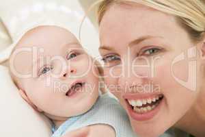 Mother and baby indoors smiling