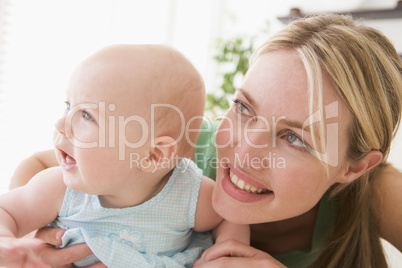 Mother in living room with baby smiling