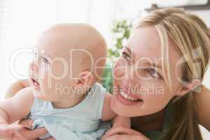 Mother in living room with baby smiling