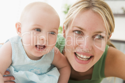 Mother in living room with baby smiling