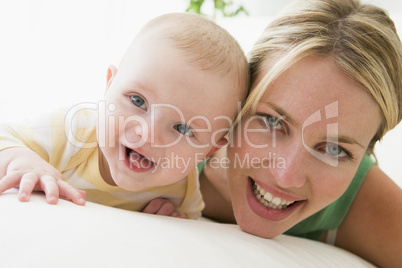 Mother and baby indoors smiling