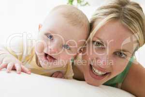 Mother and baby indoors smiling