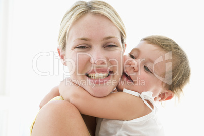 Mother and baby indoors hugging and smiling