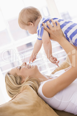 Mother in living room holding baby smiling