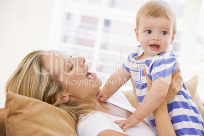 Mother in living room holding baby smiling