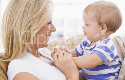 Mother in living room holding baby smiling