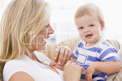 Mother in living room holding baby smiling