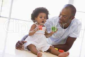 Father and daughter indoors playing and smiling