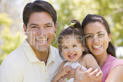 Family standing outdoors smiling