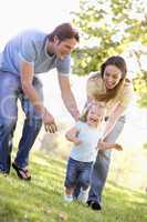 Family running outdoors smiling