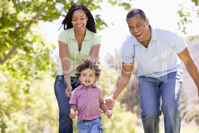 Family running outdoors smiling